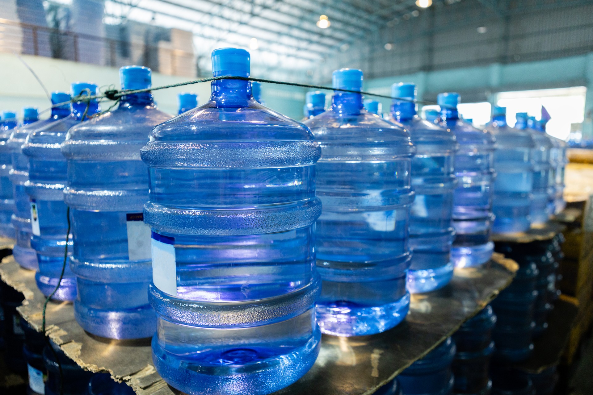 Plastic bottle or tank for drinking water in production line of factory. Process of filling water into plastic bottles to bring out to consumers. gallon drink water manufacturing.